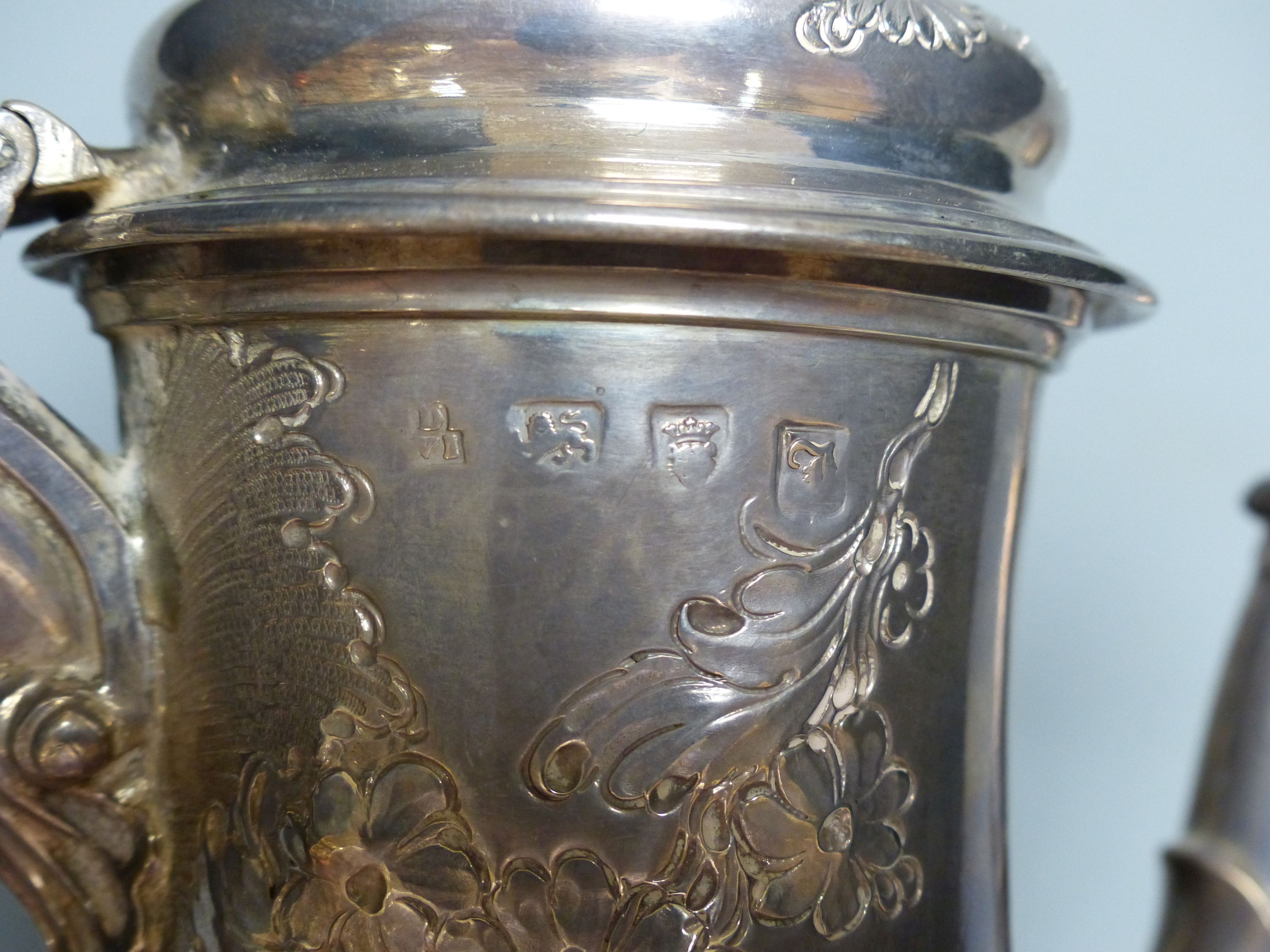 An early George III silver coffee pot, with later embossed decoration, maker ?D over WI,